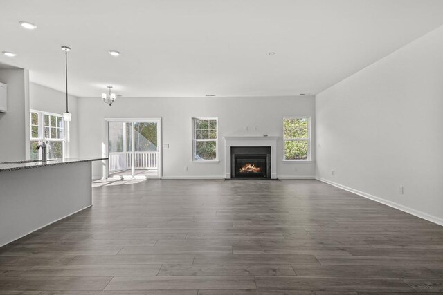 LOT476 Driftwood Dr, Greenbackville, VA 23356 - unfurnished living room with dark wood finished floors, a fireplace with flush hearth, recessed lighting, and baseboards