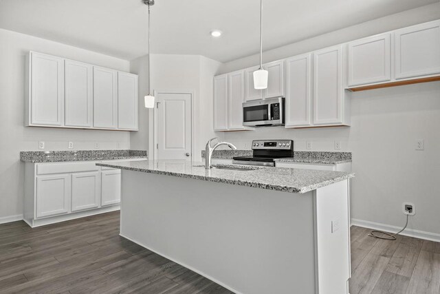 LOT476 Driftwood Dr, Greenbackville, VA 23356 - kitchen featuring stainless steel appliances, dark wood finished floors, white cabinets, light stone countertops, and a center island with sink