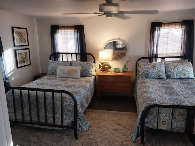 bedroom with multiple windows and ceiling fan