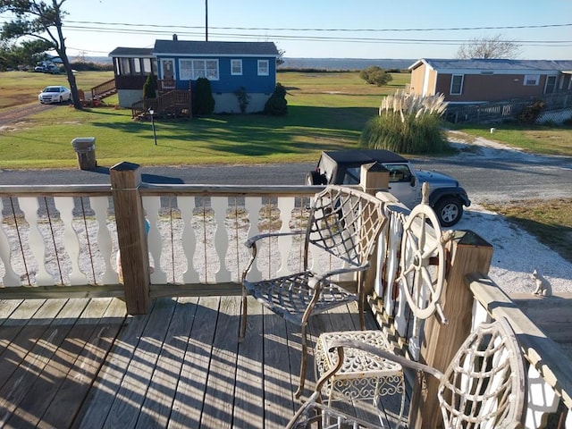 wooden terrace with a yard