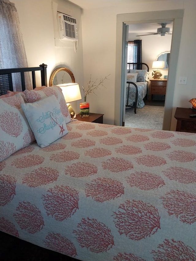 bedroom with an AC wall unit