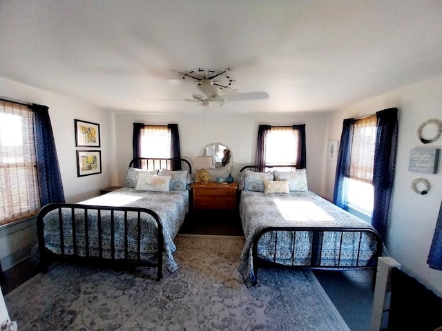 bedroom with ceiling fan and multiple windows