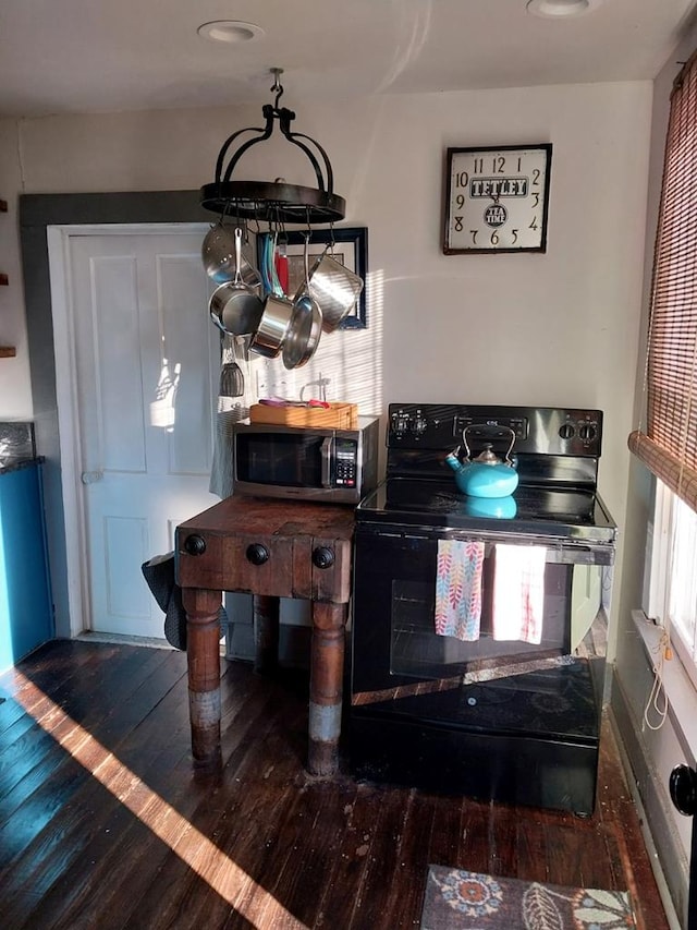 details featuring dark wood-type flooring and black range with electric cooktop