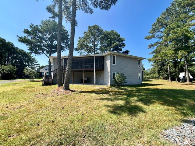 back of house with a sunroom and a yard