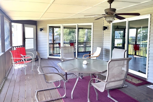 sunroom featuring ceiling fan