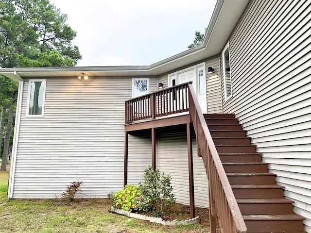 view of property exterior with a deck