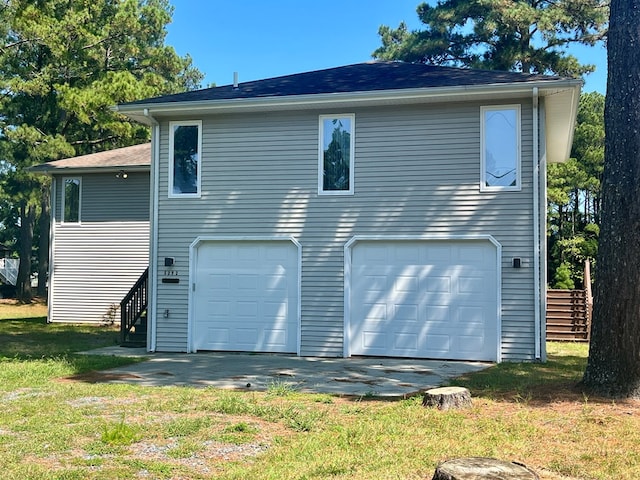 rear view of property with a garage