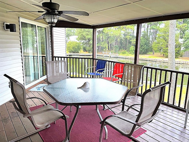 sunroom / solarium with a healthy amount of sunlight and ceiling fan