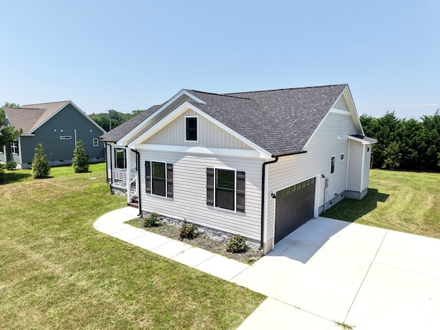 27192 Castle Row, Cape Charles, VA 23310 - view of front facade featuring a shingled roof, concrete driveway, a front lawn, a garage, and board and batten siding