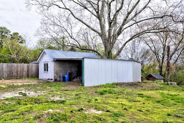 view of pole building with fence
