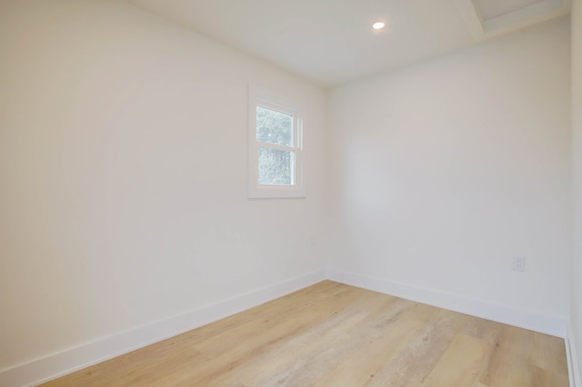 spare room with light wood-style floors, baseboards, and recessed lighting