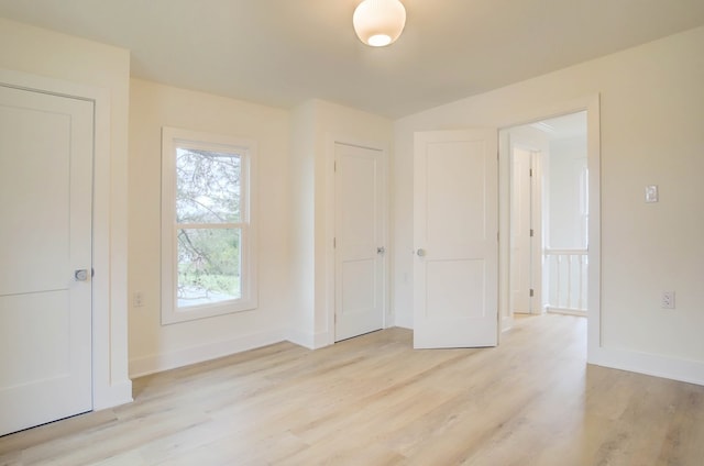 interior space featuring light wood-style floors and baseboards