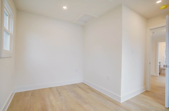 unfurnished room with baseboards, recessed lighting, and light wood-style floors