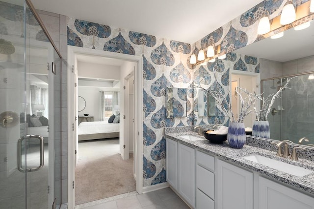 bathroom with tile patterned flooring, vanity, and walk in shower