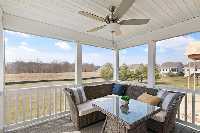 sunroom featuring ceiling fan, wooden ceiling, and a wealth of natural light