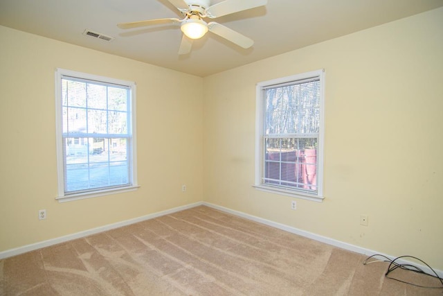 empty room with ceiling fan and light colored carpet