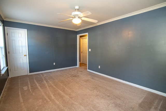 unfurnished room featuring light colored carpet, ceiling fan, and crown molding