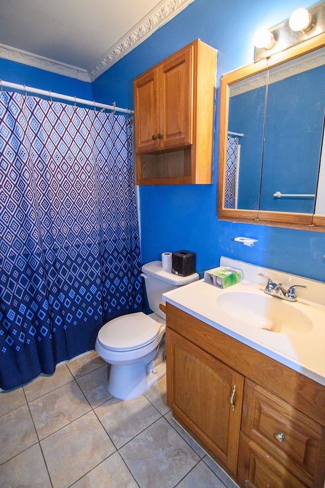 bathroom featuring tile patterned flooring, vanity, toilet, and ornamental molding