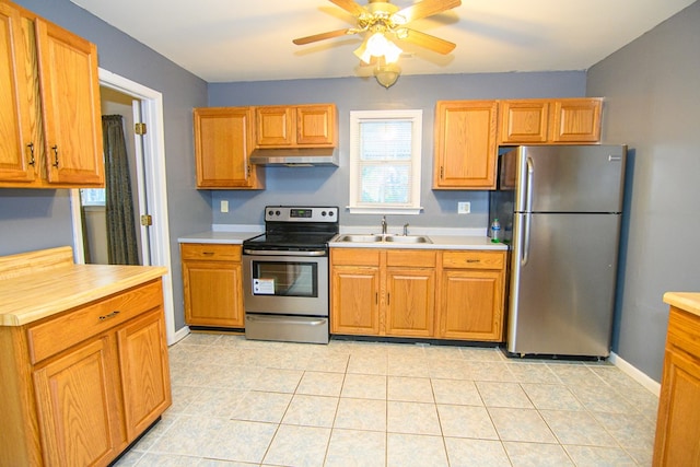 kitchen featuring ceiling fan, sink, light tile patterned floors, and stainless steel appliances