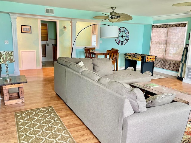 3250 Colona St, Chincoteague, VA 23336 - living room featuring a ceiling fan, light wood-style flooring, baseboards, and decorative columns