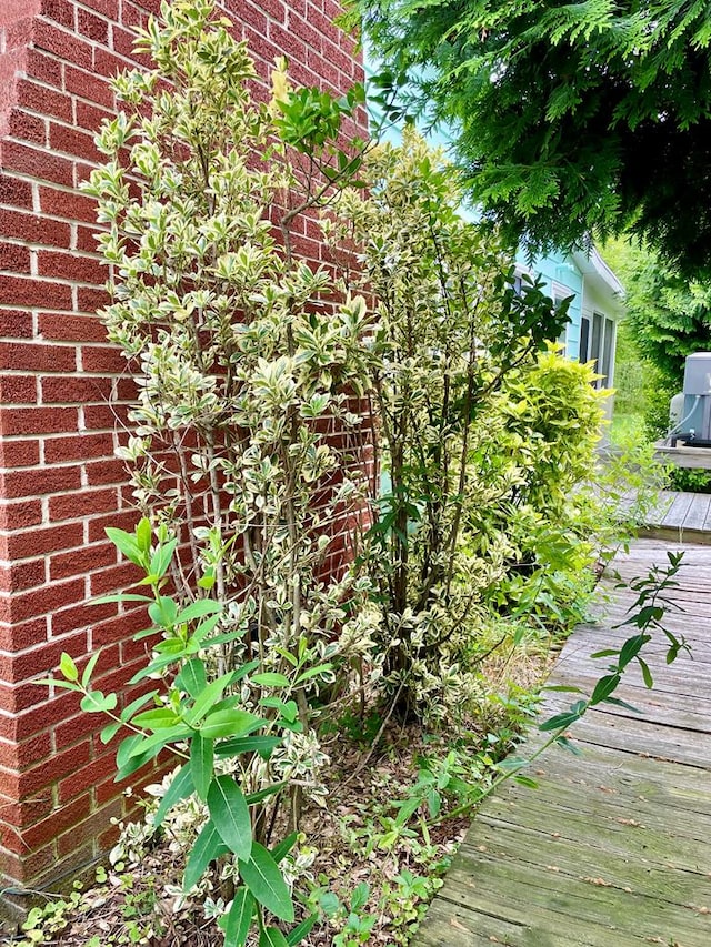 3250 Colona St, Chincoteague, VA 23336 - view of side of home featuring brick siding and a deck