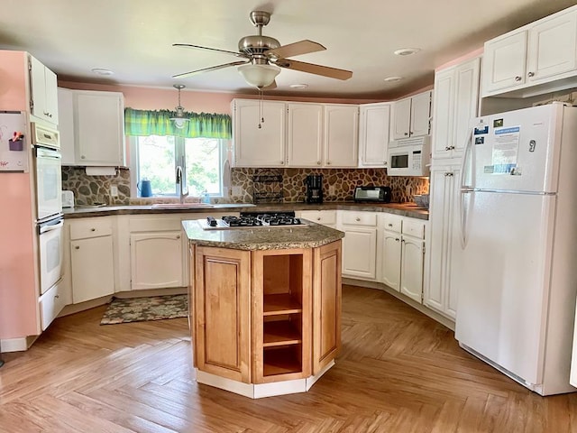 3250 Colona St, Chincoteague, VA 23336 - kitchen featuring white appliances, a ceiling fan, dark countertops, backsplash, and a sink