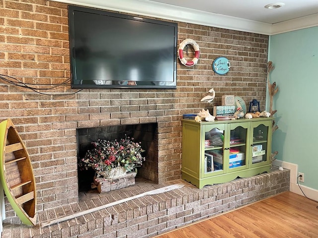 3250 Colona St, Chincoteague, VA 23336 - detailed view of wood finished floors, crown molding, and a brick fireplace
