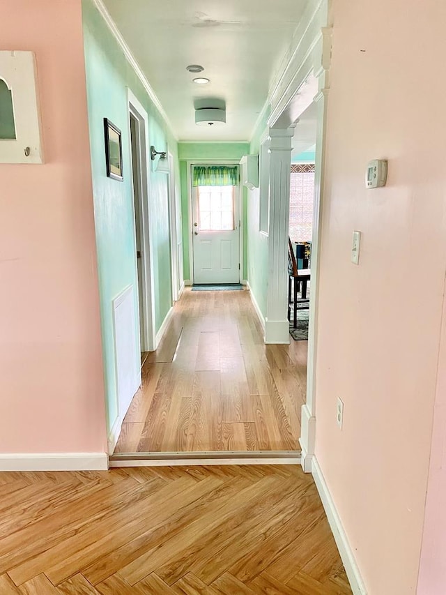3250 Colona St, Chincoteague, VA 23336 - hallway with baseboards, crown molding, ornate columns, and wood finished floors