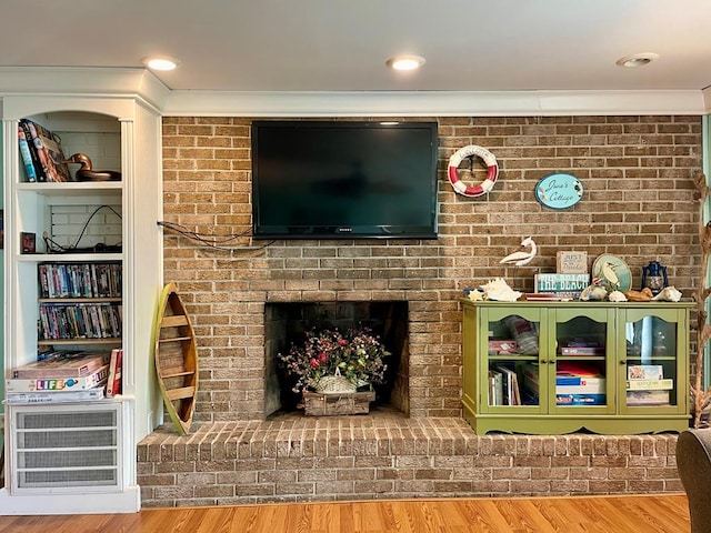 3250 Colona St, Chincoteague, VA 23336 - living room with wood finished floors, ornamental molding, and a fireplace