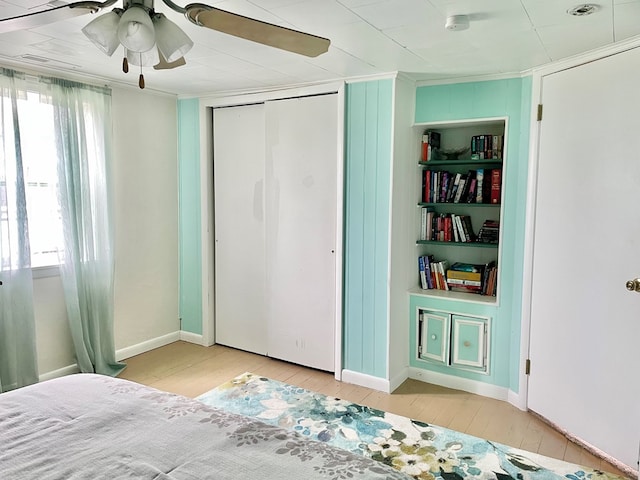 3250 Colona St, Chincoteague, VA 23336 - unfurnished bedroom featuring wood-type flooring, multiple windows, crown molding, and a ceiling fan