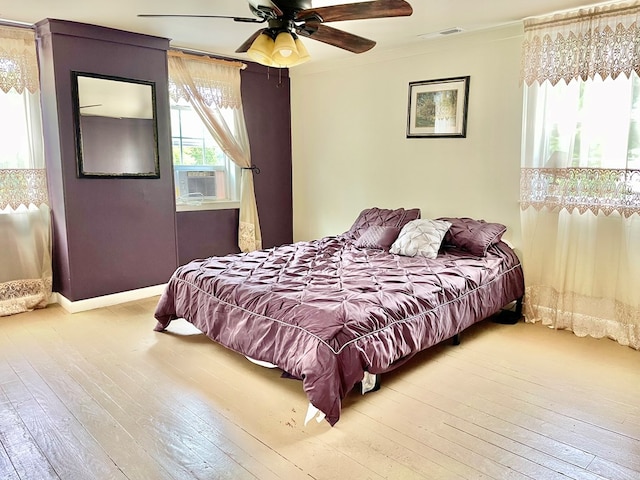 3250 Colona St, Chincoteague, VA 23336 - bedroom featuring wood-type flooring, crown molding, a ceiling fan, and baseboards