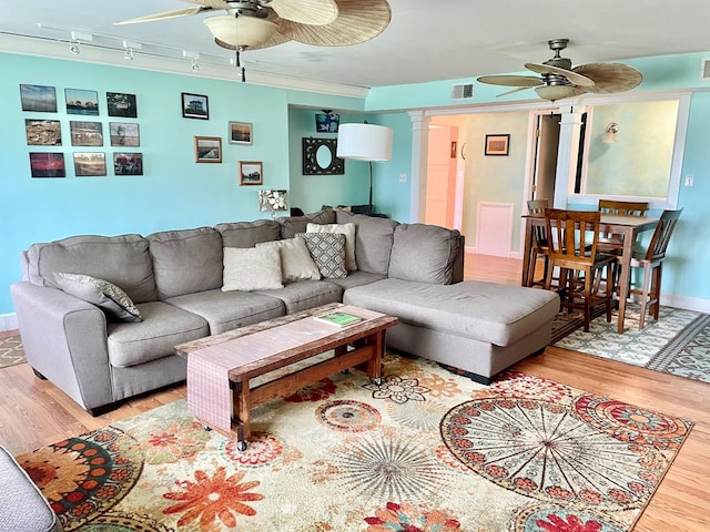 3250 Colona St, Chincoteague, VA 23336 - living room featuring ceiling fan, wood finished floors, decorative columns, and track lighting