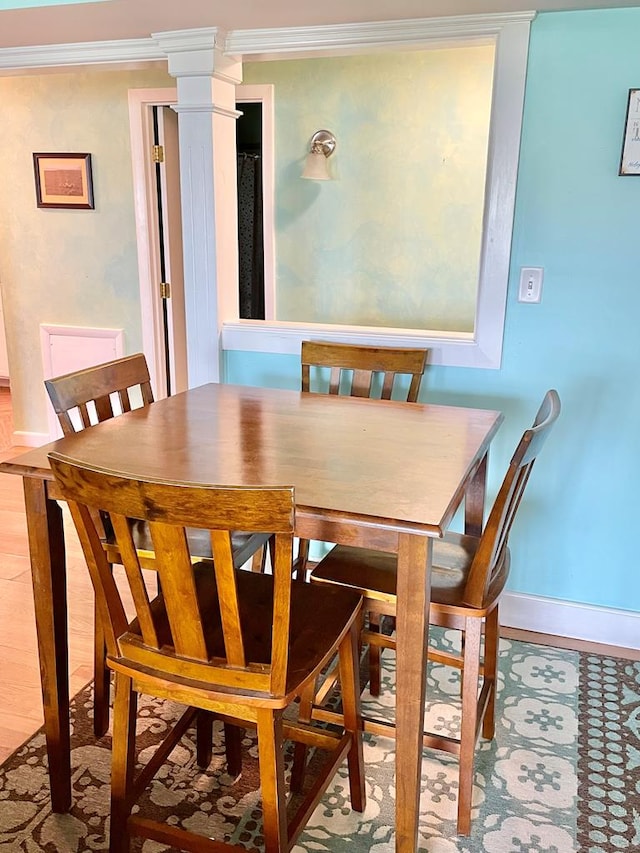 3250 Colona St, Chincoteague, VA 23336 - dining space with baseboards, crown molding, and decorative columns