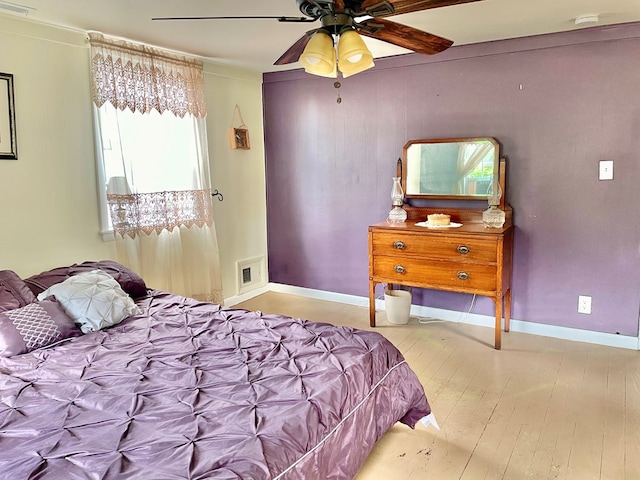 3250 Colona St, Chincoteague, VA 23336 - bedroom featuring baseboards, a ceiling fan, and wood finished floors
