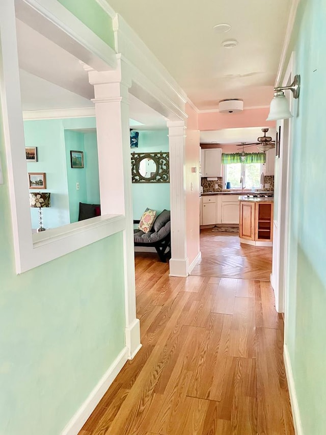 3250 Colona St, Chincoteague, VA 23336 - hall with decorative columns, light wood-style floors, and baseboards
