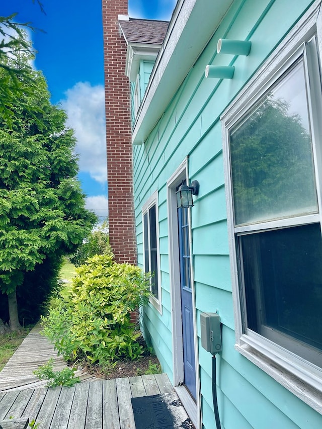 3250 Colona St, Chincoteague, VA 23336 - view of side of property with a chimney