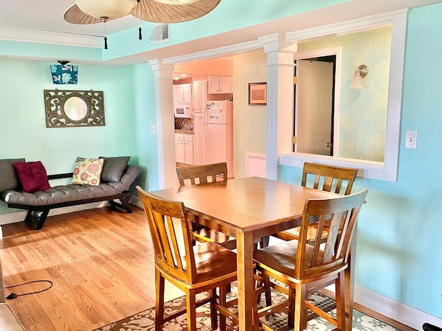3250 Colona St, Chincoteague, VA 23336 - dining room featuring light wood-style floors, ornate columns, baseboards, and ceiling fan