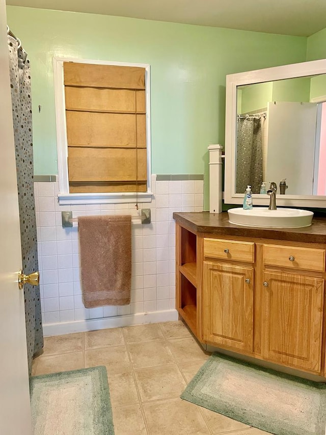 3250 Colona St, Chincoteague, VA 23336 - bathroom with tile walls, tile patterned floors, vanity, wainscoting, and curtained shower