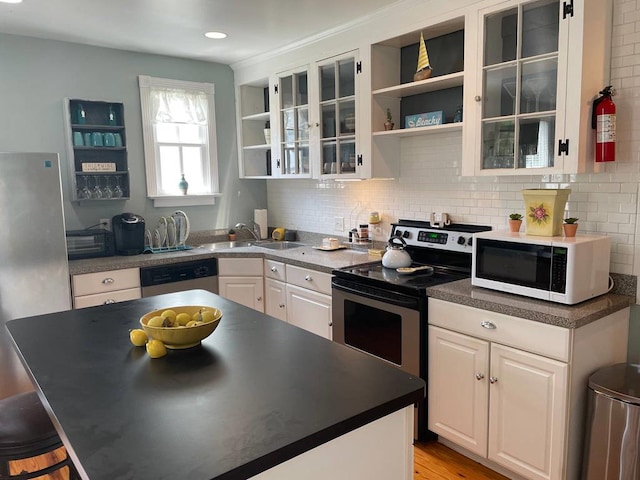 405 Randolph Ave, Cape Charles, VA 23310 - kitchen with open shelves, appliances with stainless steel finishes, a sink, and glass insert cabinets