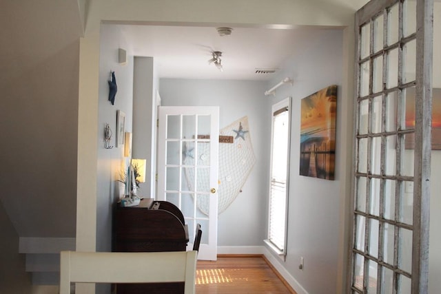 405 Randolph Ave, Cape Charles, VA 23310 - doorway to outside with baseboards, visible vents, and wood finished floors