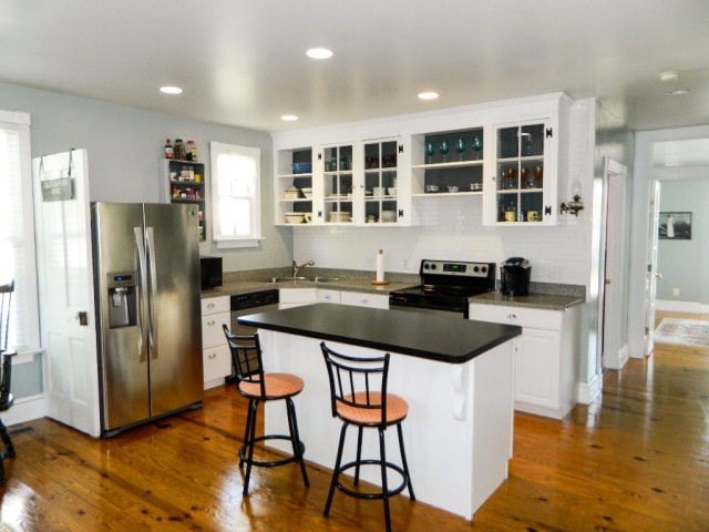405 Randolph Ave, Cape Charles, VA 23310 - kitchen featuring open shelves, dark wood-style floors, white cabinetry, and stainless steel appliances