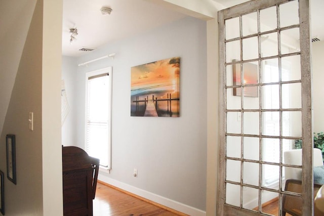405 Randolph Ave, Cape Charles, VA 23310 - corridor with wood finished floors, visible vents, and baseboards