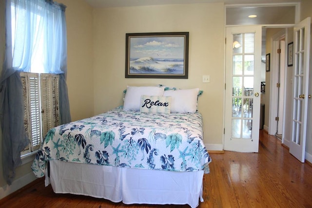 405 Randolph Ave, Cape Charles, VA 23310 - bedroom featuring multiple windows, wood finished floors, and baseboards