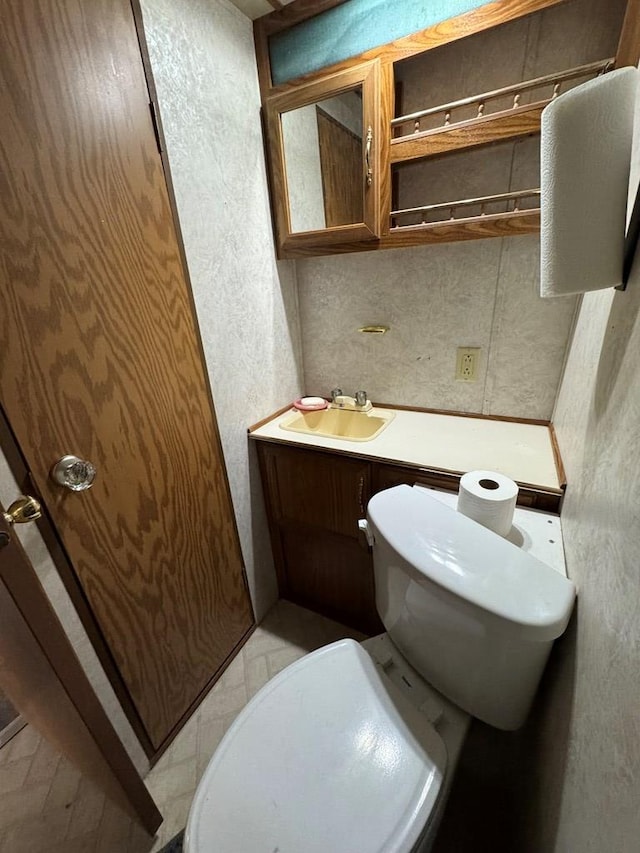 bathroom featuring toilet and a sink