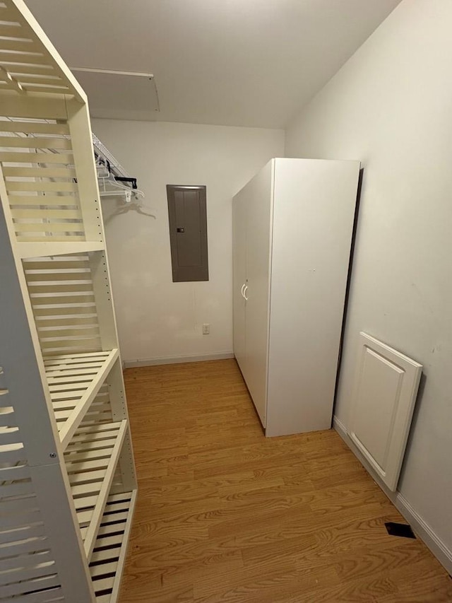 walk in closet featuring electric panel and light wood-style flooring