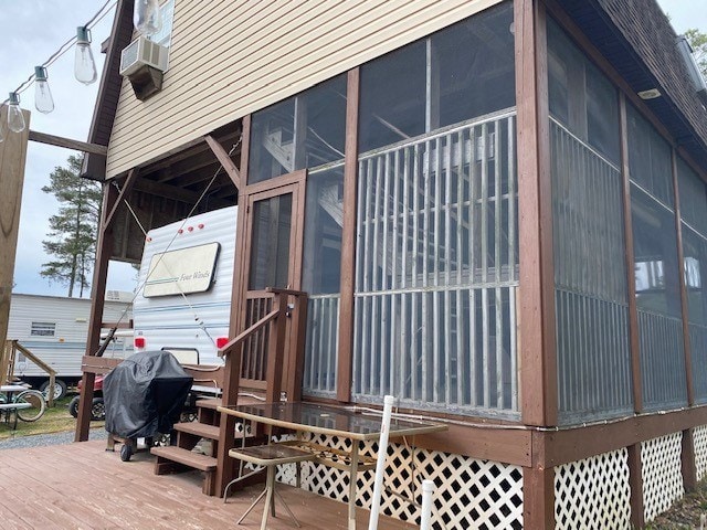 view of side of home with a carport and a sunroom