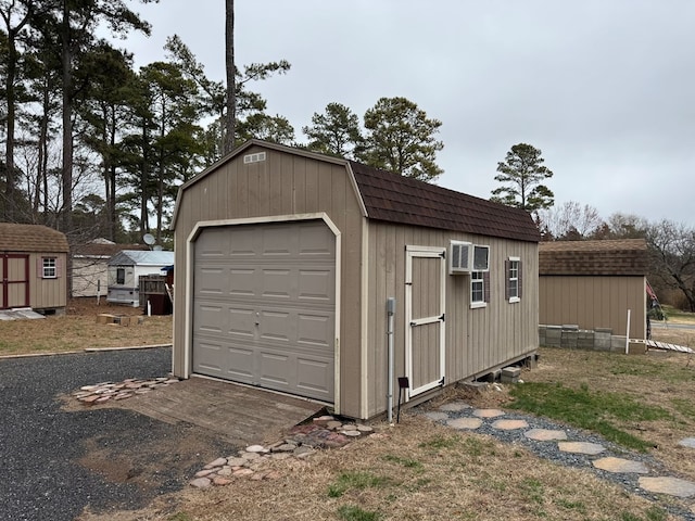 detached garage featuring a storage unit