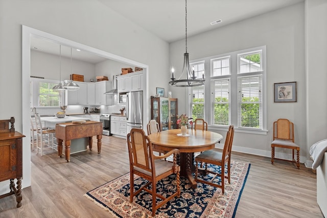 8 Perny Ct, Cape Charles, VA 23310 - dining area featuring light wood finished floors, a notable chandelier, baseboards, and visible vents
