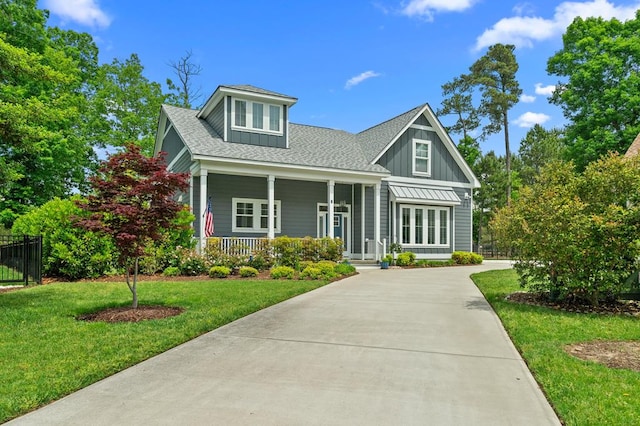 8 Perny Ct, Cape Charles, VA 23310 - craftsman-style house featuring a porch, roof with shingles, a front yard, and board and batten siding