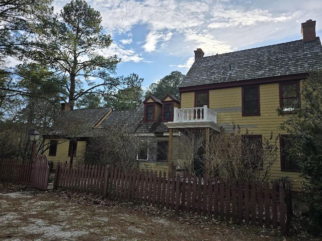 exterior space featuring a chimney and a fenced front yard